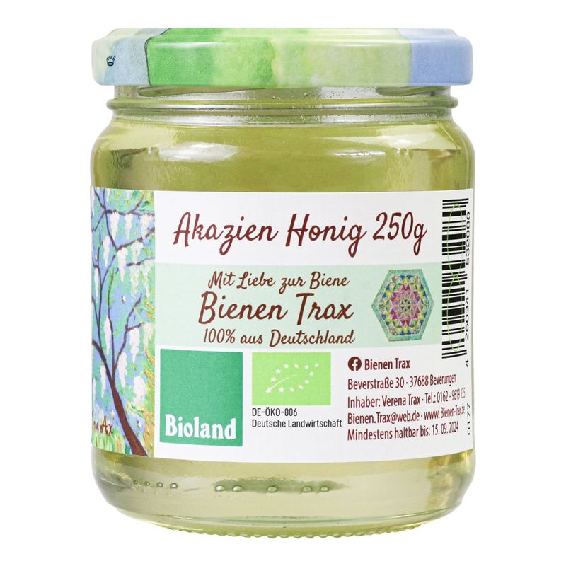 Familienimkerei Bienen-Trax Unser Akazienhonig stammt von den herrlich duftenden zarten weißen Blüten der Robinie (sommergrüner Laubbaum). Ebenso zart und mild ist sein Geschmack. Reiner Akazienhonig ist sehr klar bis durchsichtig, kann aber auch einen grünlich goldenen Schimmer ann - Produktbild